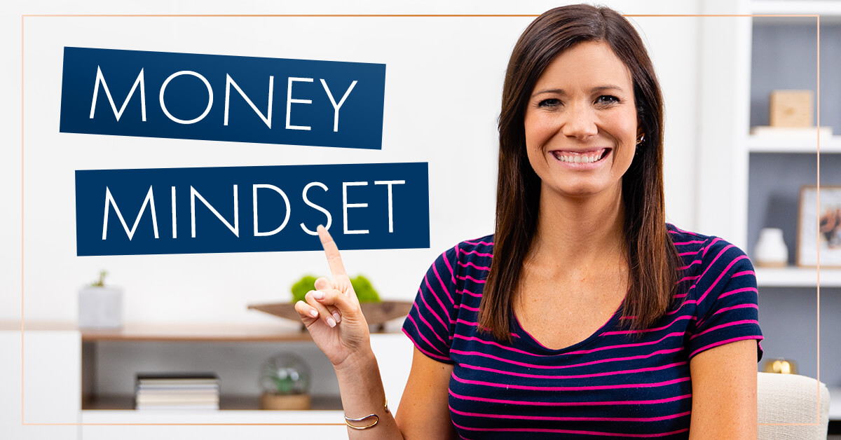 Rachel Cruze pointing to a sign that says money mindset.